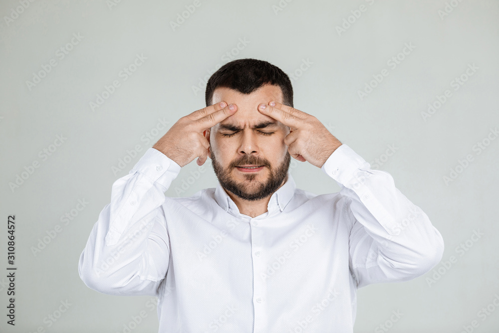 doubtful bearded man thinking about something on gray background. doubtful bearded man thinking about something on gray background.