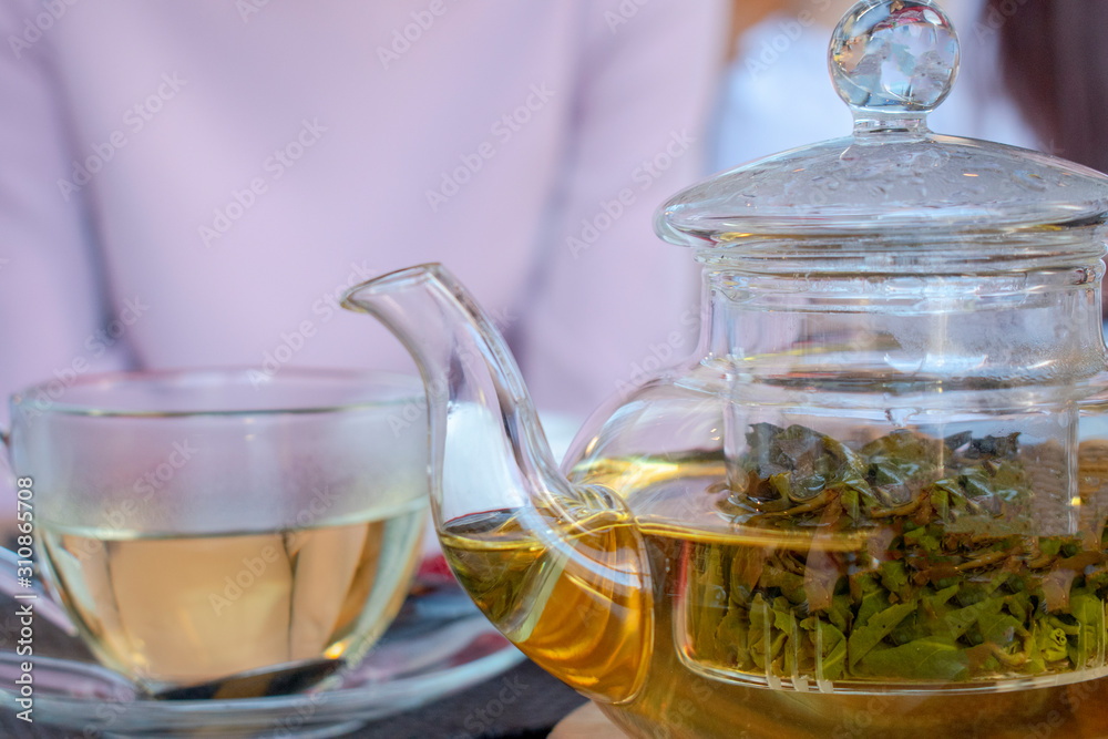 green tea in a teapot and a mug green tea in a teapot and a mug