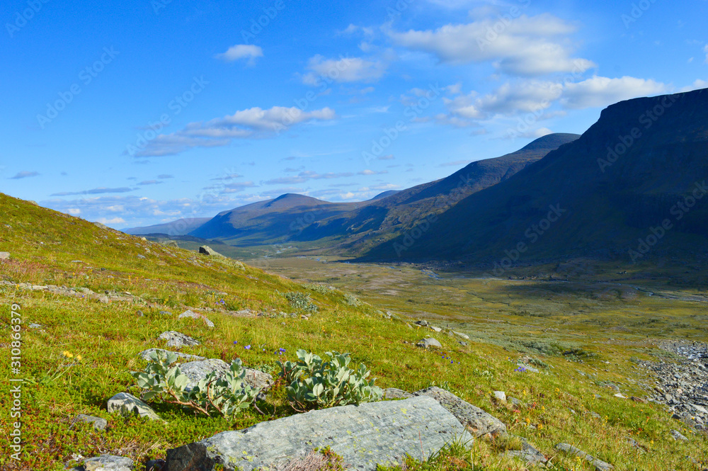 Fototapeta premium Hiking and backpacking in the valley of the highest Swedish mountains. Nikkaluoakta and Kebnekaise valley