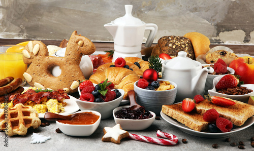 Breakfast served with coffee, orange juice, croissants, cereals and fruits. Balanced diet. Continental breakfast on christmas
