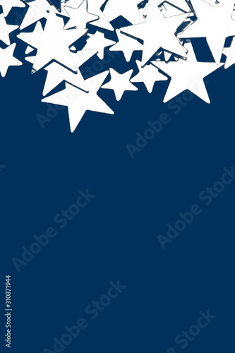 Fototapeta Naklejka Na Ścianę i Meble -  Beautiful silver stars isolated on blue background. Stylish background for your text. The concept of the celebration, Christmas, New Year, birthdays, ceremonies, events, etc.
