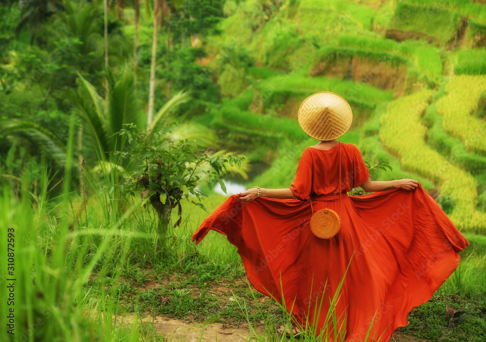 Woman walking on Tegalalang Rice Terrace, Bali Woman walking on Tegalalang Rice Terrace, Bali
