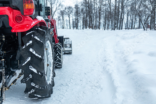snow tractor rear wheel close-up on a winter park background