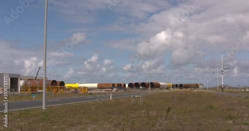 storage of large monopiles, steel foundations for offshore wind farms on a quay in Rotterdam Seaport Maasvlakte 2