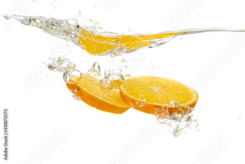 Fototapeta Naklejka Na Ścianę i Meble -  whole orange and tangerine and sliced slices falls under water