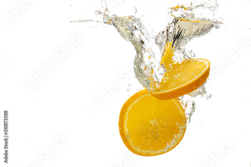 Fototapeta Naklejka Na Ścianę i Meble -  whole orange and tangerine and sliced slices falls under water