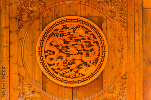 Carving of Chinese dragon and phenix on a wooden door