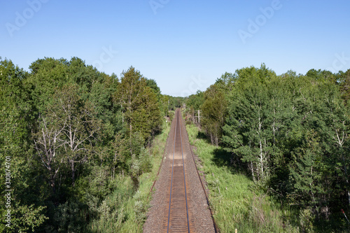 Fototapeta Naklejka Na Ścianę i Meble -  Overhead View of Empty Tracks Through Green Countryside