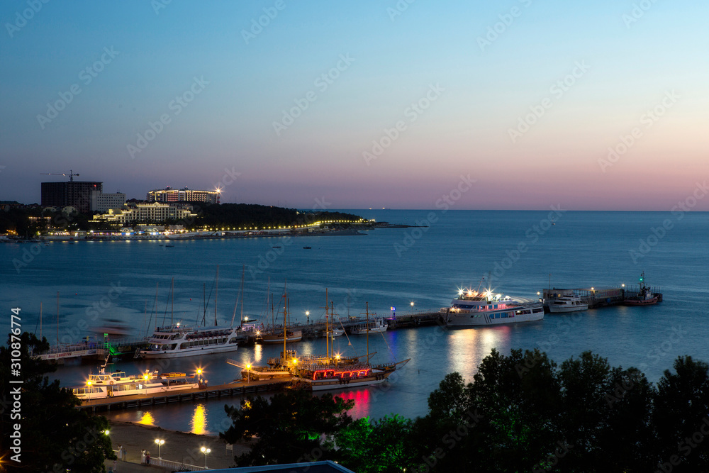Night panorama of the resort of Gelendzhik, the Black sea. Gelendzhik Bay. sea pier with standing pleasure ships and yachts. 