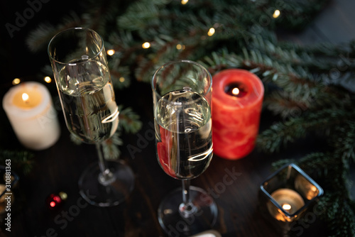 Christmas tree plate with green and black olives, cheese.Glasses of champagne