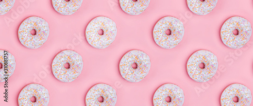 Creative background with delicious glazed donuts