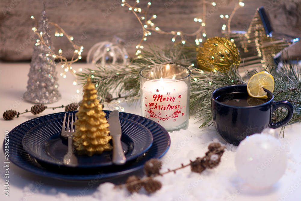Exposition of Christmas candles light, hot tea, blue plate, its beautiful day, Merry Christmas the best day in the year.

