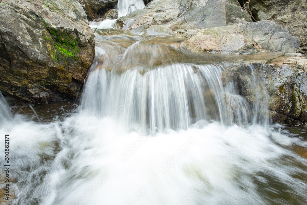 Fototapeta premium landscape photo. small waterfall Flowing through the channel rock. sarika waterfall in thailand.