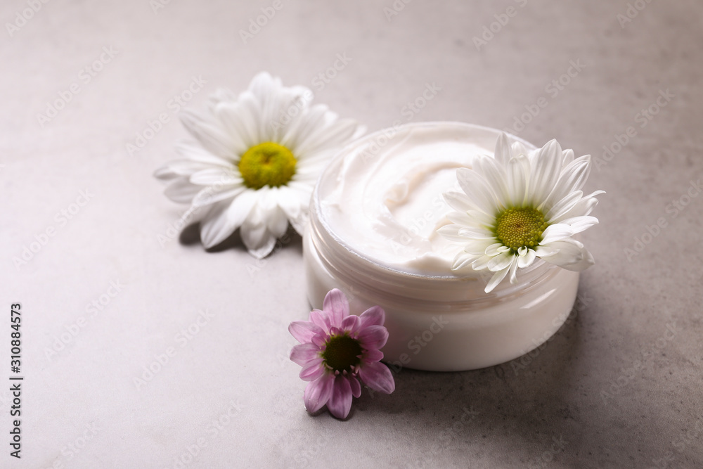 Moisturizer face body skin care wrinkle cream & chamomile flowers, grunged stone textured table background. Retinol moisturizing anti aging antioxidant skincare product for women. Copy space, close up Moisturizer face body skin care wrinkle cream & chamomile flowers, grunged stone textured table background. Retinol moisturizing anti aging antioxidant skincare product for women. Copy space, close up