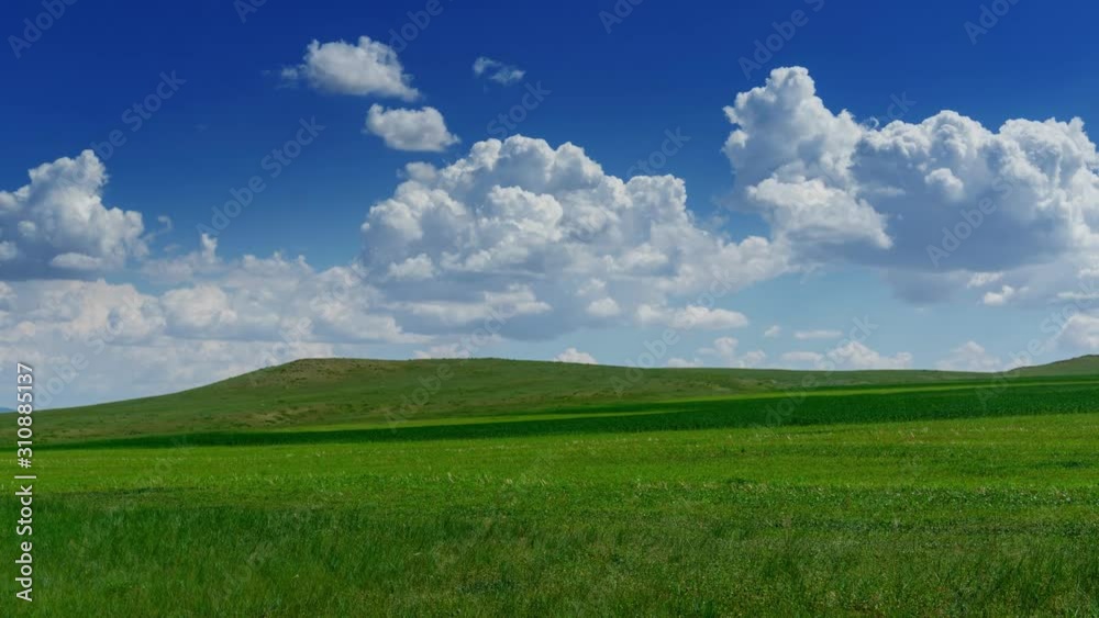 Green hill with grass under cloudy sky, timelapse 4k Green hill with grass under cloudy sky, timelapse 4k