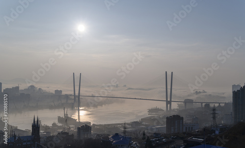 Vladivostok cityscape daylight view. Fog over the city.