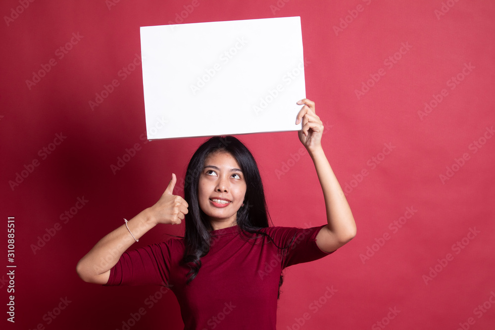 Young Asian woman show thumbs up with white blank sign. Young Asian woman show thumbs up with white blank sign.