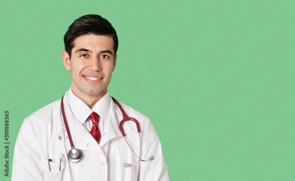Portrait of a happy male doctor in lab coat over green background Portrait of a happy male doctor in lab coat over green background