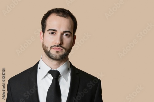 Wallpaper Mural Portrait of young businessman with short hair and beard over colored background Torontodigital.ca
