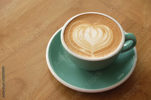hot art latte coffee on wood table
