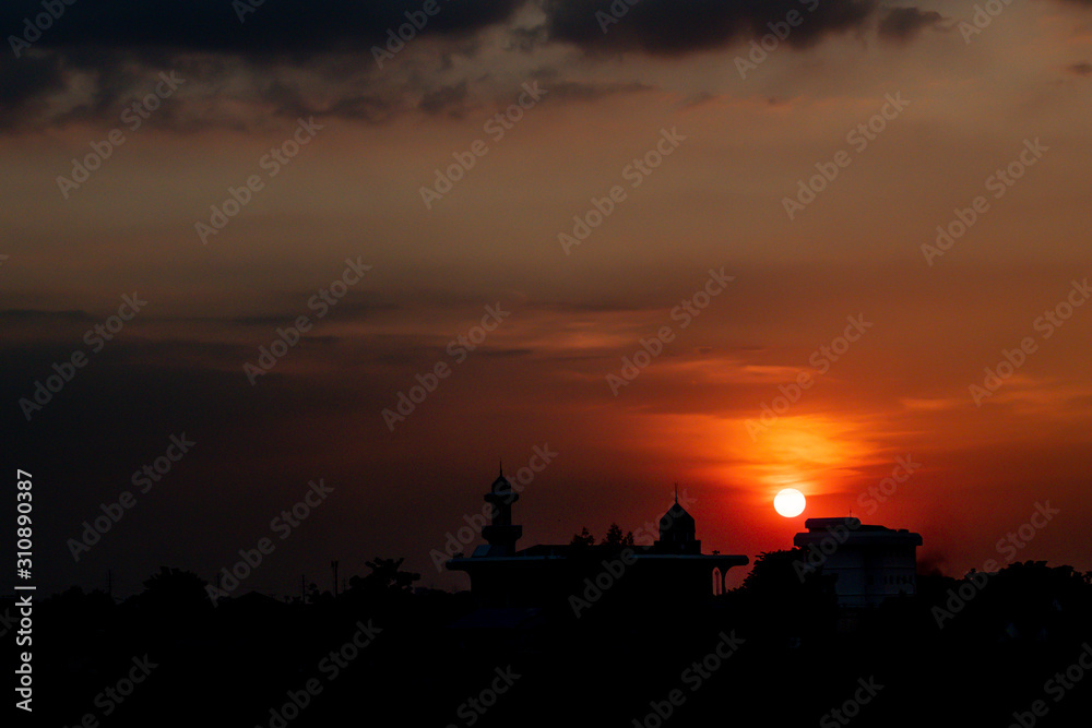 Concept of religion Islam. Silhouette of cultural building architecture over sunset sky background.