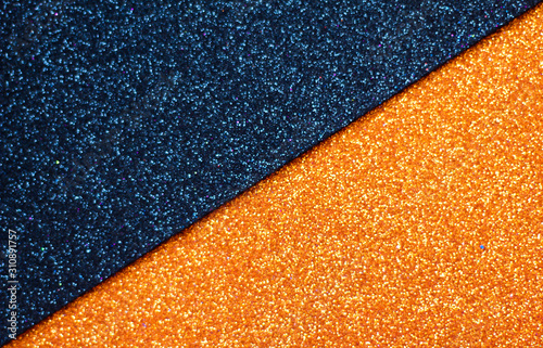 Black and orange glitter background, selective focus, free copy space