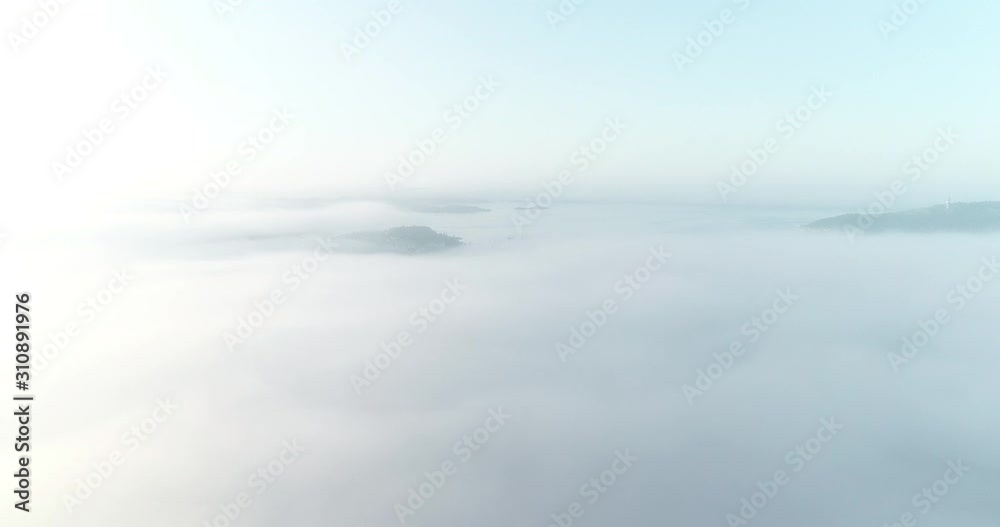 Aerial view of fog covering Kristiansand city in the morning during a sunrise. (Norway). Aerial view of fog covering Kristiansand city in the morning during a sunrise. (Norway).