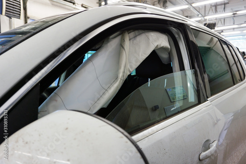 Side airbag of a modern car deployed in the incident. Repair of a modern car, air bag system, preservation of life and health in case of accidents. Work of a modern air bag systems.
