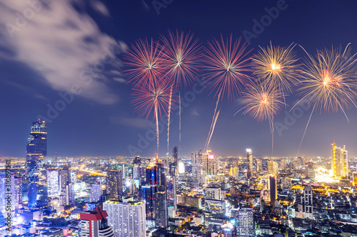 New Year colorful fireworks with cityscape bangkok skyline in night time, Many hotel, temple and height building for business stand in the heart of Bangkok,Thailand.