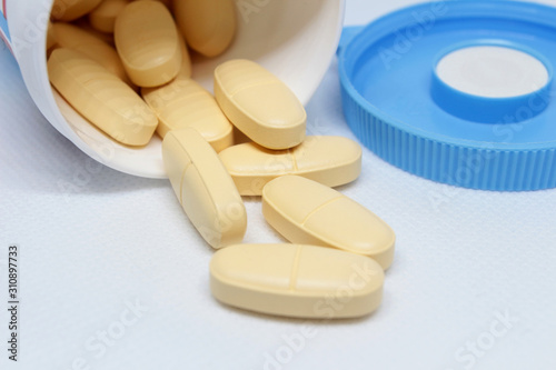 close-up, food supplement tablets spilling out of the package