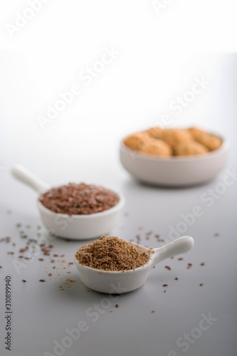 flax seeds and flax seeds powder in small cups