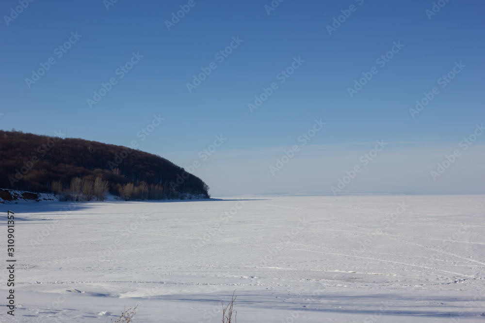 Fototapeta premium Winter snowy landscape with hills and trees