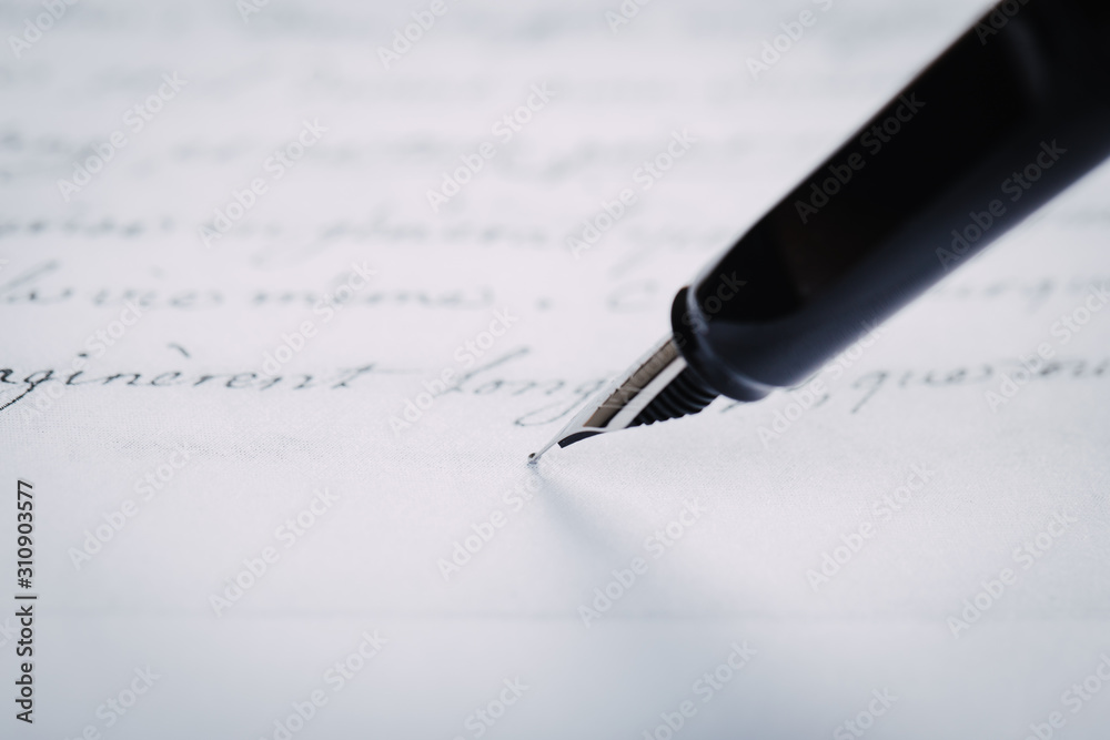 Fototapeta premium Fountain pen on an ancient handwritten letter. Old story. Retro style.