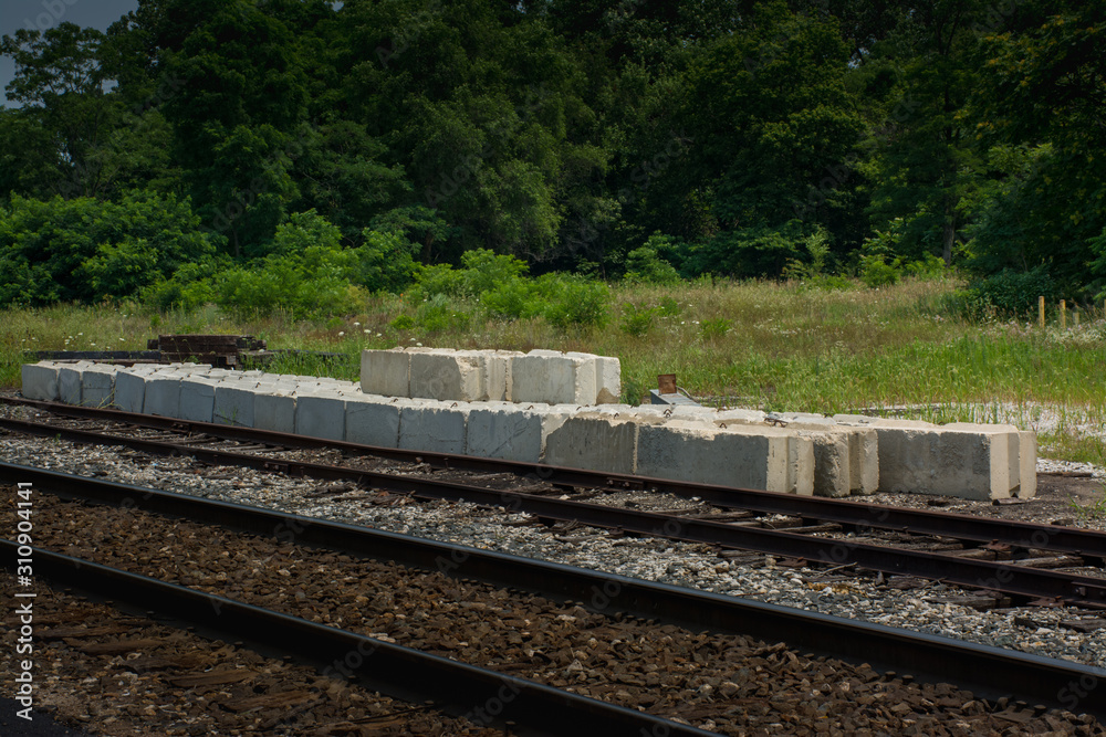 Fototapeta premium Concrete blocks for repair staged next to a railroad