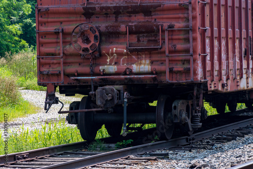 Close-up of rusty boxcar wheels on railroad siding photo