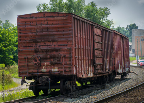 Rusty boxcar on railroad siding photo