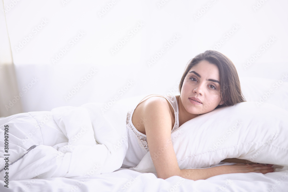 beautiful young woman basking in bed in the morning. Beautiful beautiful young woman basking in bed in the morning. Beautiful