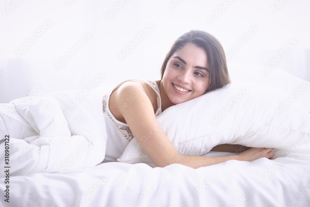 beautiful young woman basking in bed in the morning. Beautiful