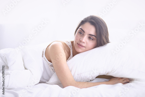 beautiful young woman basking in bed in the morning. Beautiful