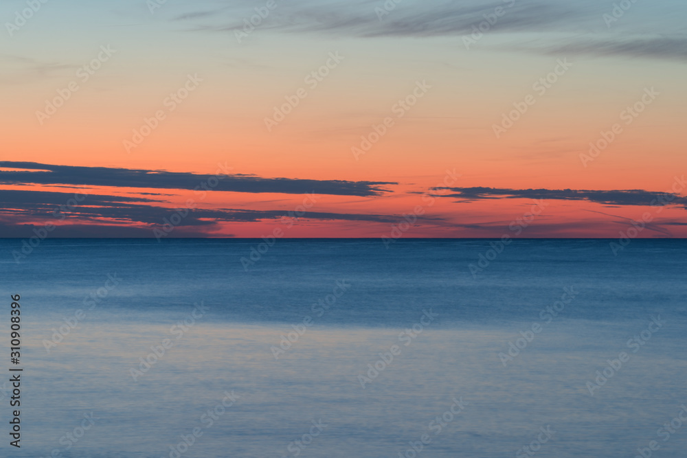 sunset on a calm sea with saturated colors background