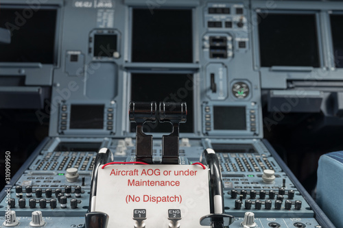 Modern Passenger Airplane Cockpit with warning sign that the aircraft is AOG (Aircraft on ground) or under Maintenance and it is not allowed to dispatch it, means Don't fly with this airplane!