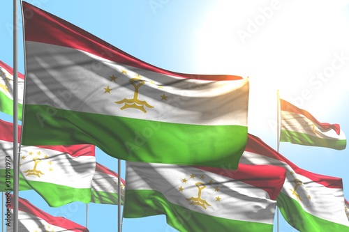 cute many Tajikistan flags are wave on blue sky background - any feast flag 3d illustration..