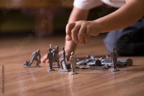 Cropped Boy With Toy Soldiers On Floor
