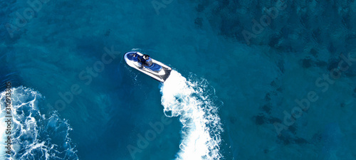 Aerial drone ultra wide top view photo of jet ski water crafts cruising in deep blue Mediterranean sea © aerial-drone