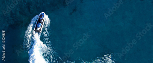 Aerial drone ultra wide top view photo of jet ski water craft cruising in deep blue Mediterranean sea