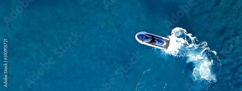 Aerial drone ultra wide top view photo of jet ski water craft cruising in deep blue Mediterranean sea