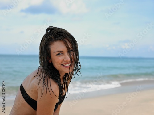 Smiling Young Woman In Bikini At Beach