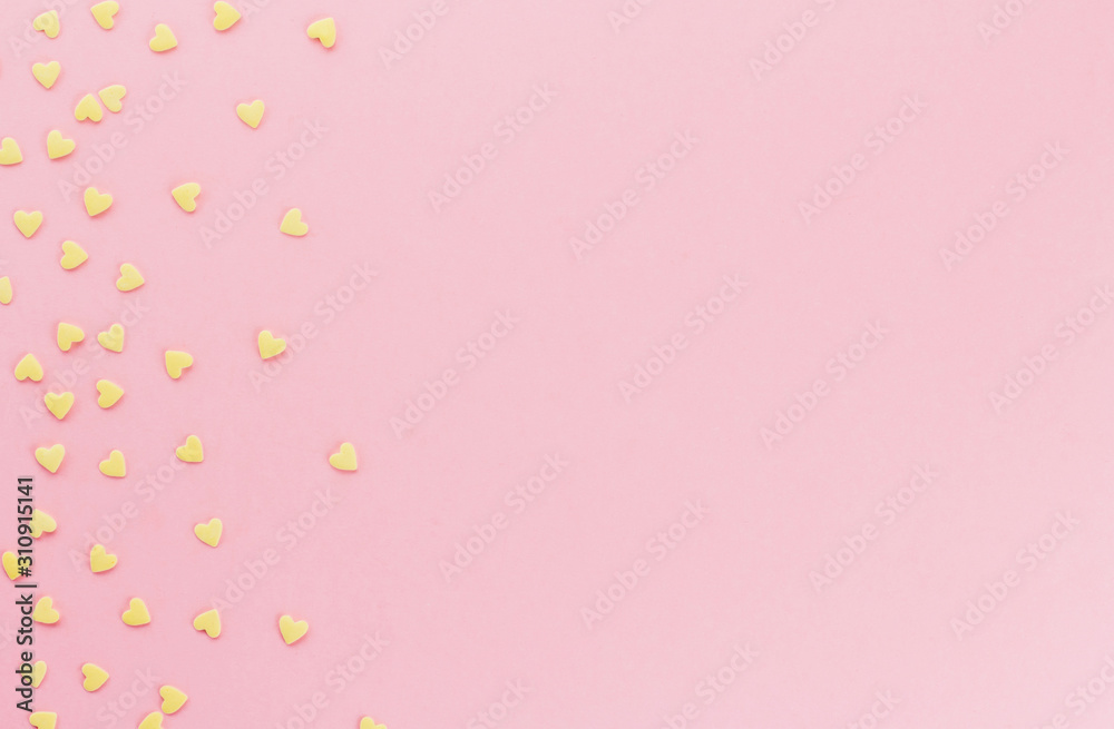 yellow confetti in the shape of hearts on a pink background copy space. yellow confetti in the shape of hearts on a pink background copy space.