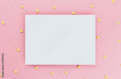 card on a background of heart-shaped confectionery confetti on a pink background copy space. Yellow hearts. © Марина Красавина