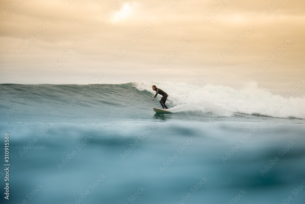 surfer riding waves on the island of fuerteventura surfer riding waves on the island of fuerteventura